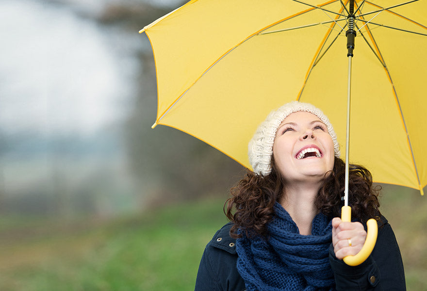 Kvinde med en paraply i regnvejr